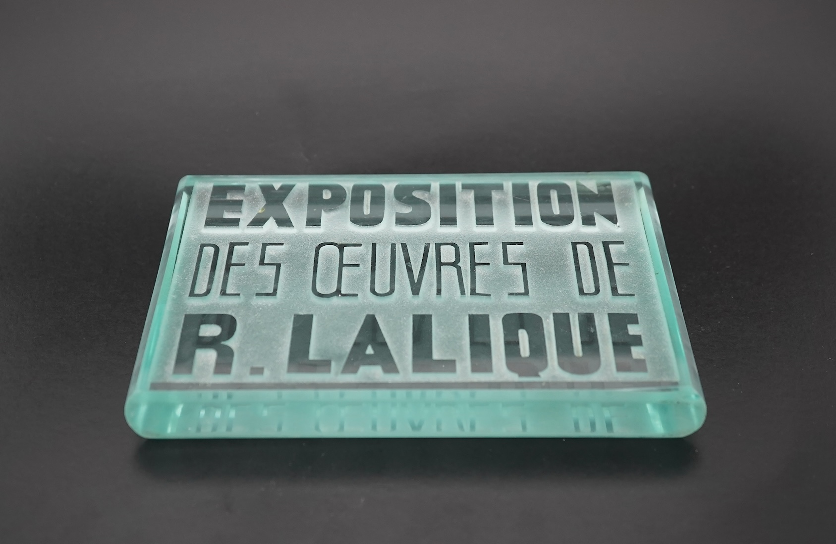 Lalique: A glass advertising plaque 'EXPOSITION DES ŒUVRES DE R.LALIQUE'